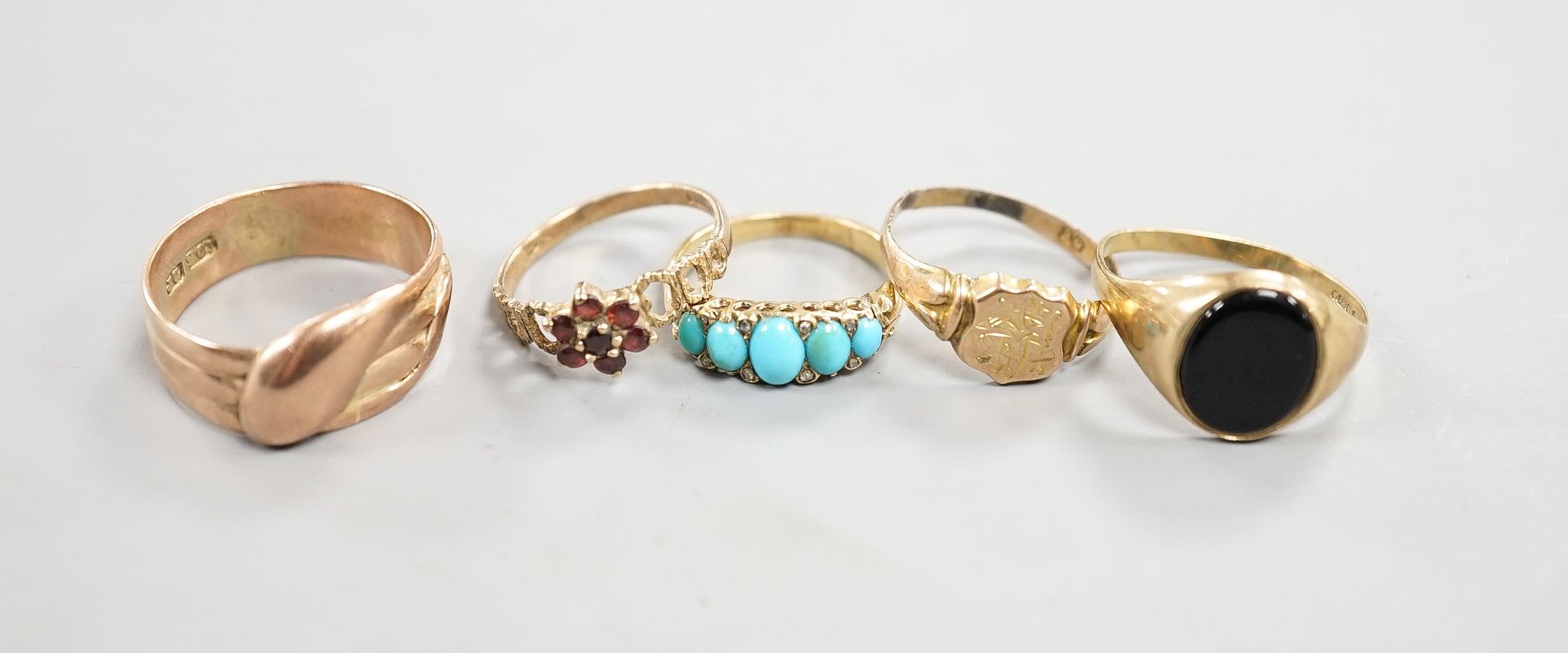 Four assorted 9ct rings including serpent(tired), signet and two gem set gross 10 grams and a yellow metal and five stone turquoise set ring, gross 3.6 grams.